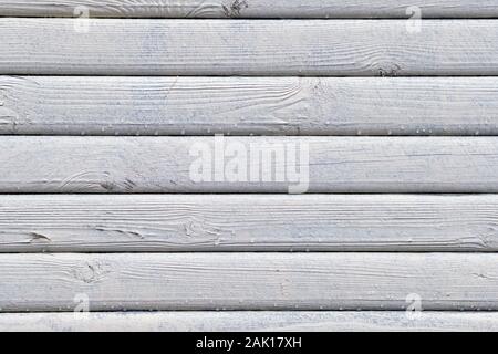 The wooden texture is painted white with drops of water. Close up. Stock Photo