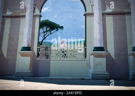 Mural of a lone woman on a balcony, painted on a wall in Saginaw, Michigan Stock Photo