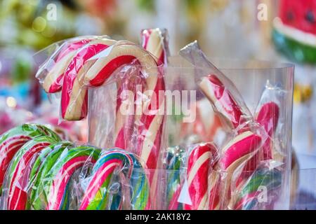 Christmas lollipops in a pack of red white on the shop window. Close up. Stock Photo