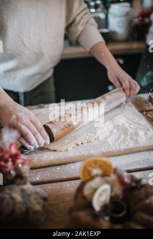Young woman in white swater make dough. Stock Photo
