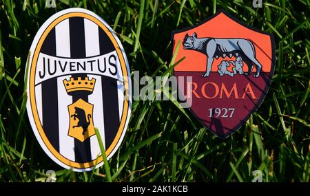 September 6, 2019, Turin, Italy. Emblems of Italian football clubs Juventus Turin and Roma on the green grass of the lawn. Stock Photo