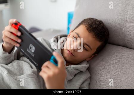 tel Aviv, Israel - January 01, 2020: A man playing Nintendo Switch Stock Photo