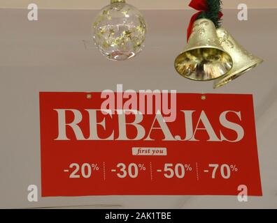 Rebajas signs seen in a shop window indicating the New Years Sales have begun in Spain.With windows still dressed for Christmas, most shops in Spain begin their New Year’s sales traditionally on January 7th day after 'Three Kings Day'. These stores at the Costa del Sol's all year round holiday resort of Torremolinos follow the regular Andalucian trend. Stock Photo