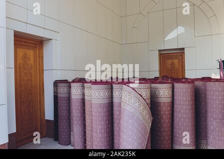 Carpets variety selection rolled up rugs shop store supermarket Stock Photo