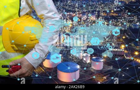 Engineer holding walkie talkie are working order at oil and gas refinery. Industry petrochemical concept image and icon connecting networking using te Stock Photo