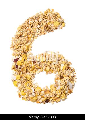Arabic numeral '6'   from muesli with coconut, berries, raisins, cereal and natural cereals  on a white isolated background. Food pattern made from gr Stock Photo