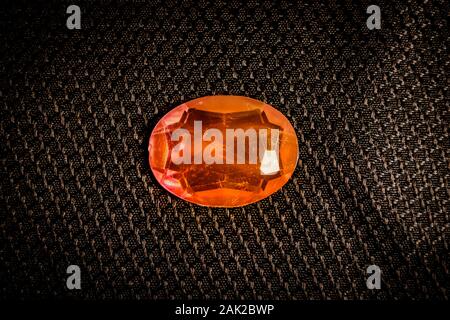 Red ruby gem stone on black background Stock Photo