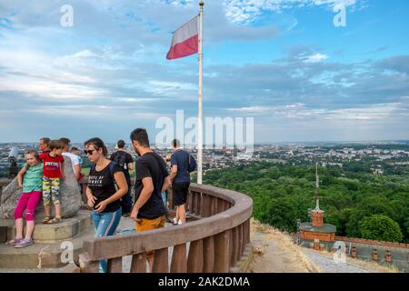 Tourists stand on the top of the Kosciuszko Mound in Kraków, Poland, with a view of the city in the distance Stock Photo