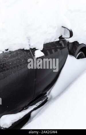 The car was completely covered with snow in the backyard. Stock Photo