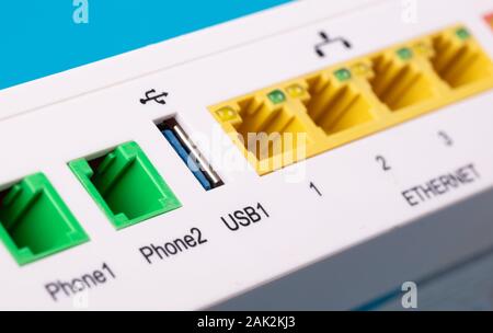 Desktop Home ADSL modem on a blue background back view, selective focus Stock Photo