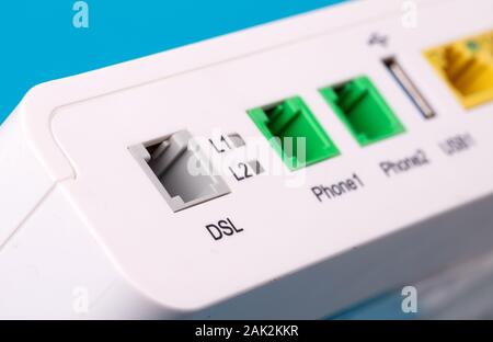 Desktop Home ADSL modem on a blue background back view, selective focus Stock Photo