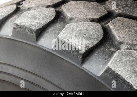 Tread of a partially worn truck tire close-up. Stock Photo
