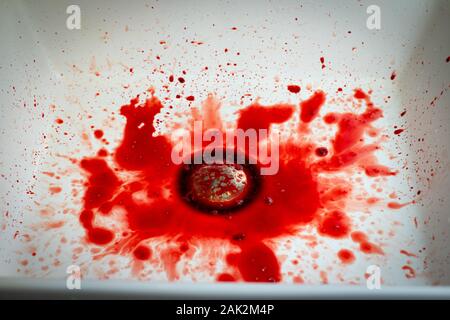 Many blood dripping into the washbasin in the bathroom, bloody and  sink Stock Photo
