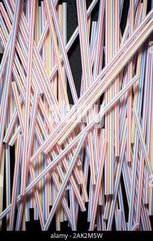 Drinking plastic straws on a black table. Stock Photo