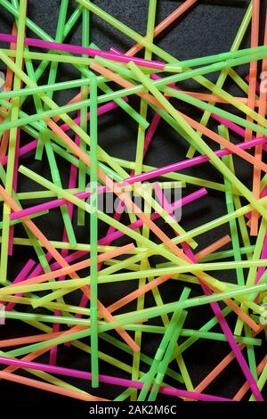 Drinking plastic straws on a black table. Stock Photo