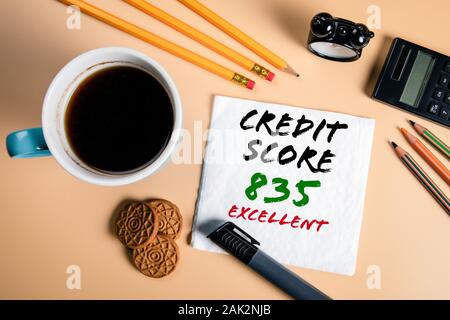 Excellent credit score. Budgeting, borrowing, plans and options concept. Text on a napkin with a cup of coffee Stock Photo