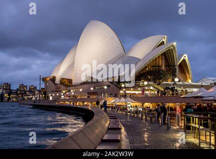 The Sydney Opera House at night. It's a global icon where it's massive 'shell' roofs are incredibly detailed. Here seen in the early evening showing r Stock Photo