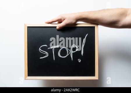 the word stop written on a blackboard Stock Photo