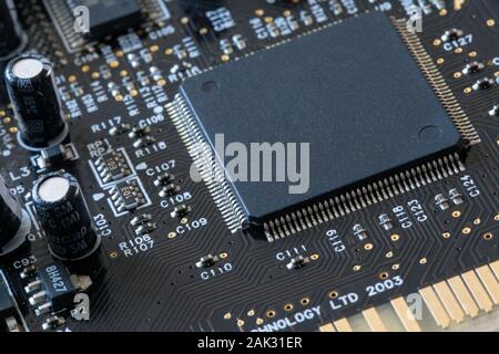 Photo of electric component in electronic device, contain black microchip as main object. Stock Photo
