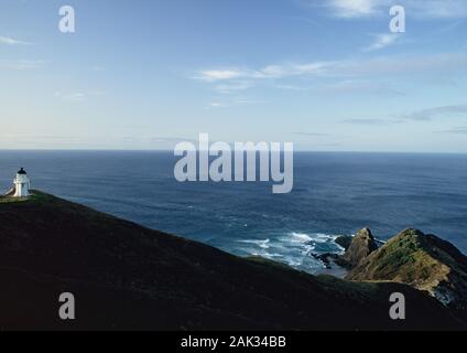 A small lighthouse stands on Cape Reinga at the northwestern point of the Aupouri Peninsula on the North Island of New Zealand. It was built in 1941. Stock Photo