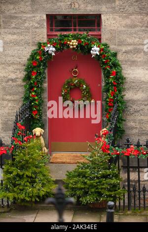 Cute miniature Christmas decorations hung on the wall in the form of a  Christmas tree. St Paul Minnesota MN USA Stock Photo - Alamy