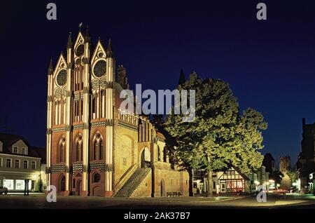 View of the lighted Gothic city hall in Tangermuende at night. It dates back to the 15th century. Tangermuende is located at the Elbe river in the fed Stock Photo