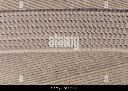 Tire tracks in the sand on the beach Stock Photo