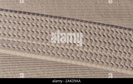 Tire tracks in the sand on the beach Stock Photo