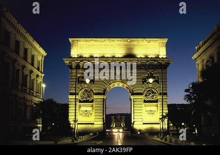 View of the triumphal arch Porte du Peyrou in Montpellier, France, at night. The triumphal arch was built in 1691 and designed in the Doric style with Stock Photo