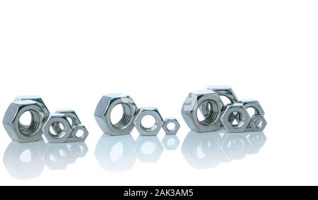 Set of metal hexagon nuts isolated on white background. Small, medium, and big of silver metal hexagon nuts. Hardware tool. Fastener with a threaded Stock Photo