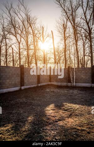 A fence around the territory of a private house made of concrete blocks. Stock Photo