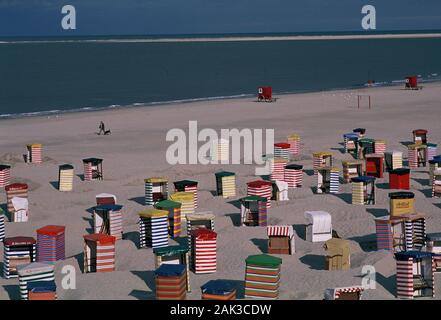 Colorful beach chairs stand at the beach in front of the boardwalk on the island of Borkum. Borkum is the most western and the biggest of the seven Ea Stock Photo