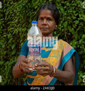 Auroville, India - 21st September 2019: Searching the world's most polluting brand in global audit of plastic waste. Stock Photo