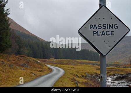 Passing Place sign on single track road in Glen Lyon, Perthshire, Scotland. Road and mountain blurred background. Stock Photo