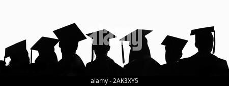 Silhouettes of students with graduate caps in a row isolated on white panoramic background. Graduation ceremony at university web banner. Stock Photo