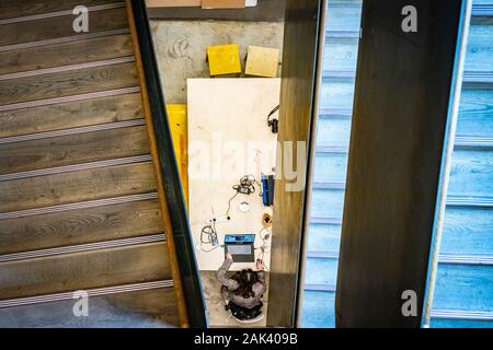 woman on laptop hot design from above with abstract staircase at the Bartlett School of Architecture London Stock Photo