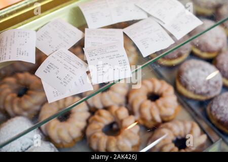 07 January 2020, Saxony, Leipzig: Remaining receipts lie on the counter of a pastry shop. Just a few days after the controversial obligation to pay receipts came into force, the regulation has met with criticism, especially from bakeries. Customers would not take the vouchers with them and the bakeries would have to throw away the freshly printed voucher right away, according to representatives of the bakers' guild. Since 1 January, merchants have had to hand over a receipt to their customers. The law on cash registers passed in 2016 is intended to combat tax fraud, for example through manipul Stock Photo