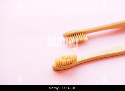 Bamboo toothbrushes on light pink background. Zero waste and use biodegradable and recyclable material concept. Flat lay. Stock Photo