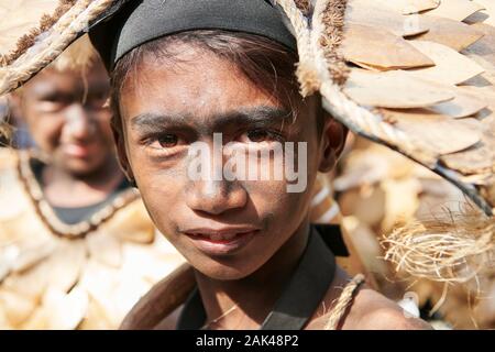 Ibajay Town, Aklan Province, Philippines - January 27, 2019: Portrait of teenage boy in native costume joining the parade at the Ati-Atihan Festival Stock Photo