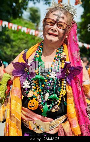 Ibajay Town, Aklan Province, Philippines: Colorful dressed old woman joining the street dancing parade at the Ati-Atihan Festival Stock Photo