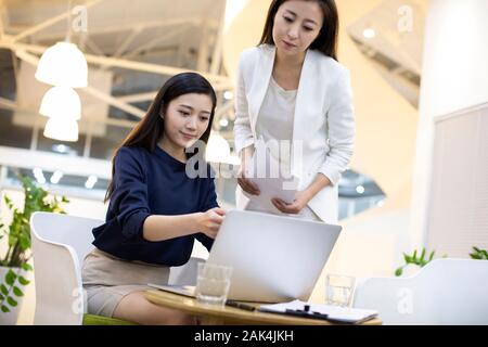 Chinese businesswomen working in office Stock Photo
