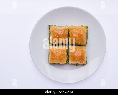 Sweet baklava on plate isolated on white Stock Photo