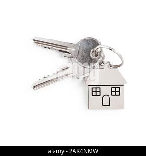 Key and house shaped keychain arrangement isolated on white background. Design element, top view, flat lay. Real estate and insurance concept Stock Photo