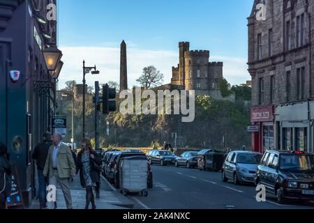 Edinburgh / Scotland / UK - 04/20/2014: View of Edinburgh city center with historic buildings and people strolling down the street, in Scotland Stock Photo