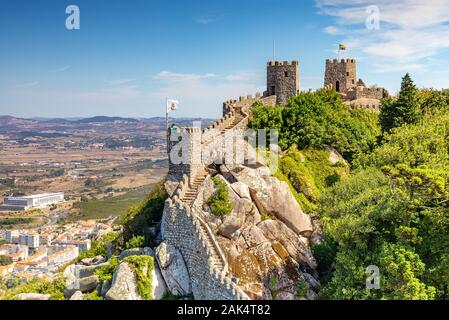Sintra, Portugal at Castle of the Moors wall with Pena National Palace in the distance. Stock Photo