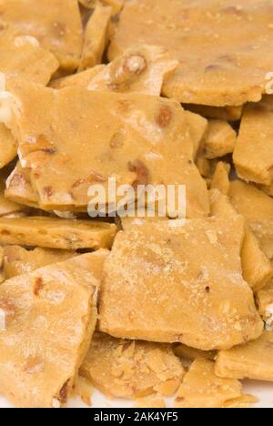 Macro shot showing all the detail of delicious and sticky homemade peanut brittle. Stock Photo