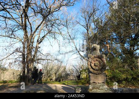 (200107) -- BOMARZO, Jan. 7, 2020 (Xinhua) -- People visit the Park of Monsters in Bomarzo, Italy, Jan. 3, 2020. Bomarzo, a village in Lazio at the foot of Mount Cimino, possesses a unique work, the Villa of Marvels, also called the Sacred Wood or Park of Monsters. lt was designed by Duke of Bomarzo, Vicino Orsini and architect Pirro Ligorio in 1552.This ltalian style garden follows geometric and perspective rationality with embellishments such as wide terraces, fountains with water games and mannerist sculptures. (Xinhua/Cheng Tingting) Stock Photo