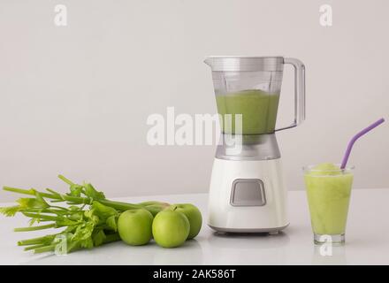 blender with celery and apples on the kitchen table, healthy eating concept Stock Photo