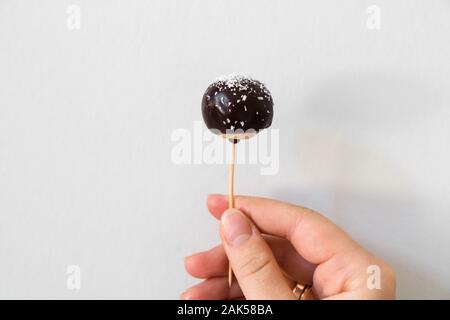 Cake pops candy sticks decorated with dark chocolate. Stock Photo