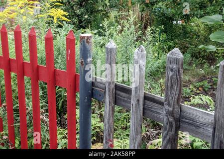 Painted and unpainted garden fence wooden fence garden Stock Photo
